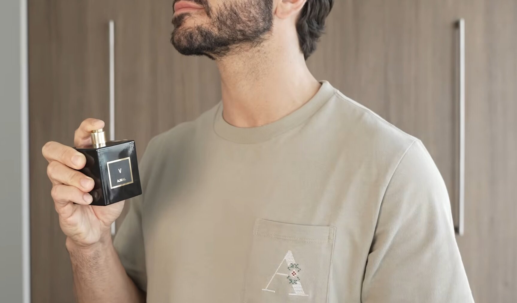 a man spraying cologne on chest without rubbing
